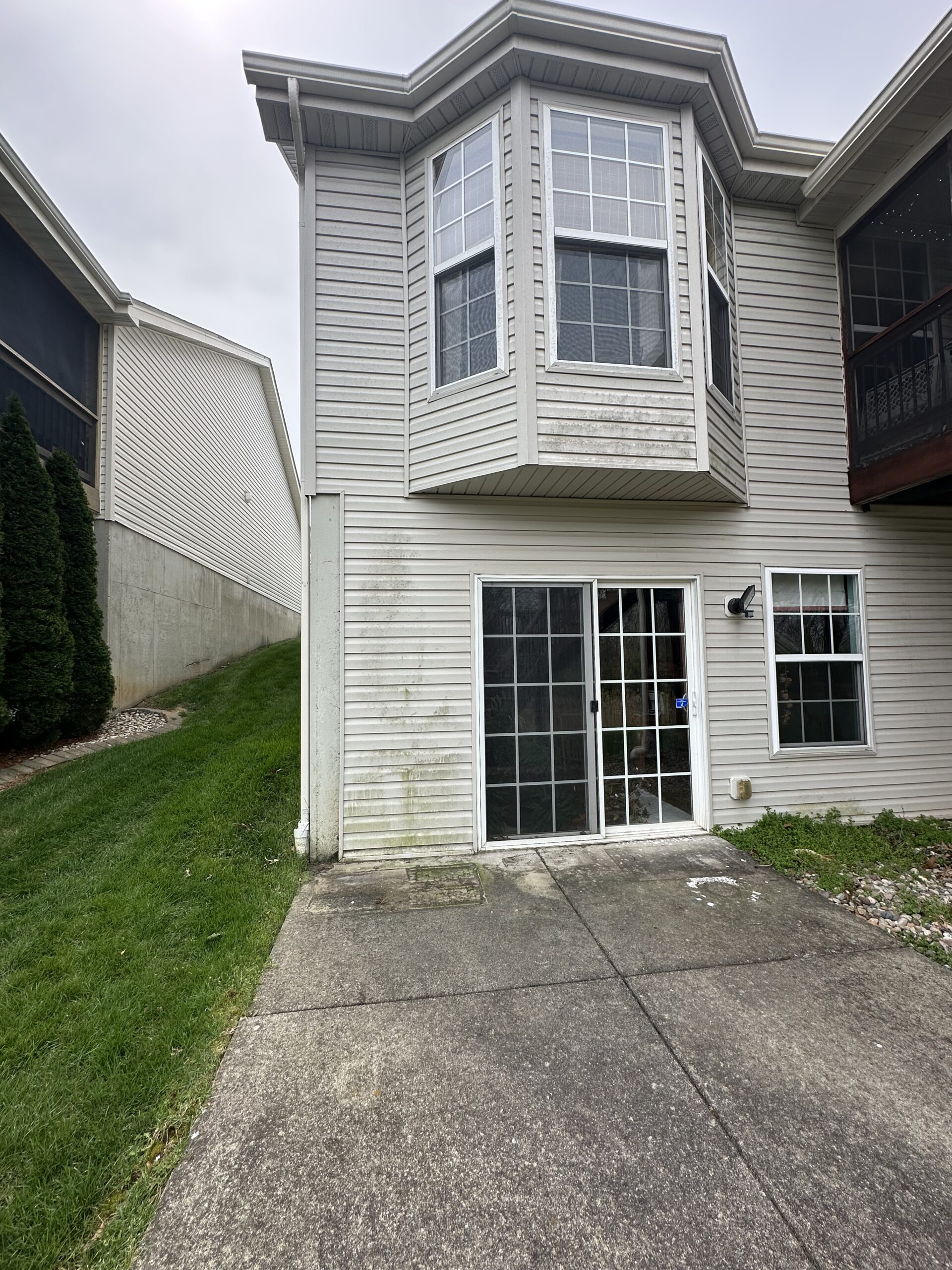 House siding before professional house washing with visible exterior buildup